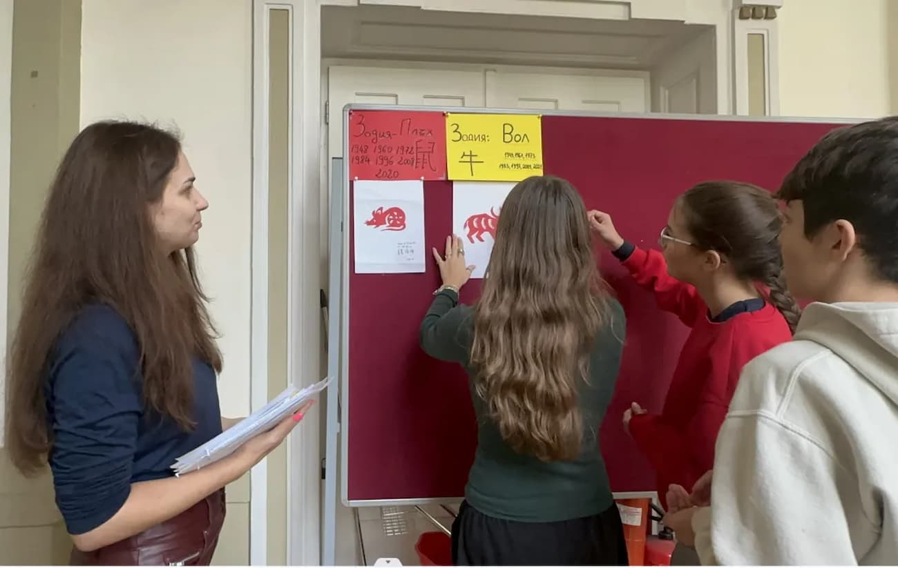 Photo 4: Teachers and students setting up the exhibition together