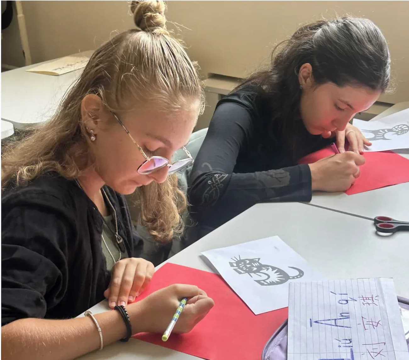 Photo 1: Students drawing designs