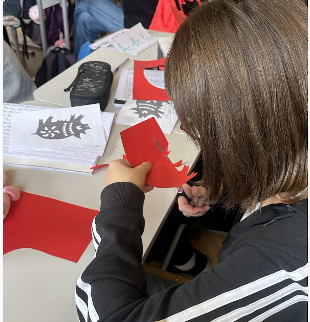 Photo 2: Students doing paper-cutting